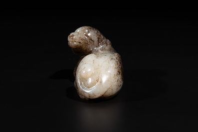 A Chinese partly black coloured white jade dog carving, Qing