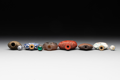 Eleven Chinese snuff bottles in amber, agate, rock crystal, lacquer, hardstone, metal and wood, 19/20th C.