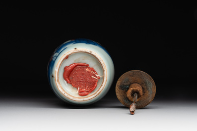 A Chinese blue, white and copper-red snuff bottle, 19th C.