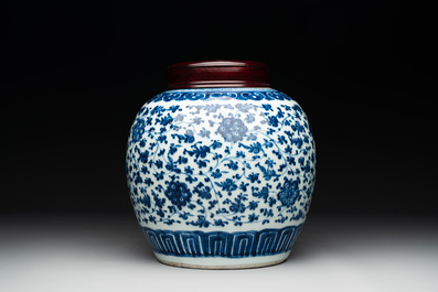 A Chinese blue and white 'flower scroll' jar with a wooden cover, Qianlong