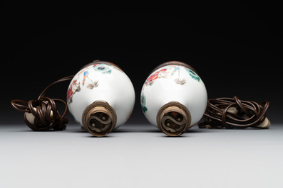 A pair of Chinese famille rose vases with figural design mounted as lamps, 19th C.