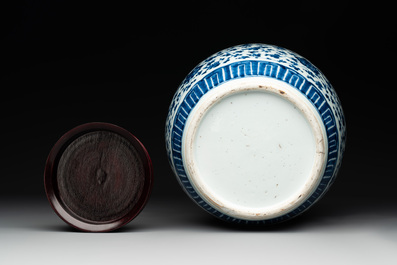 A Chinese blue and white 'flower scroll' jar with a wooden cover, Qianlong