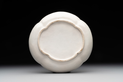 A Chinese blue and white 'butterfly' cup and saucer with applied floral design, Qianlong