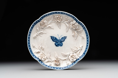 A Chinese blue and white 'butterfly' cup and saucer with applied floral design, Qianlong