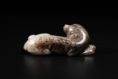A Chinese partly black coloured white jade dog carving, Qing