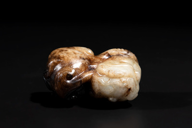 A Chinese celadon and russet jade mythical beast carving, Ming