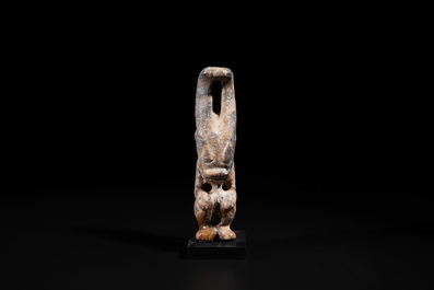 A Chinese jade carving of a crouched figure, possibly Hongshan culture
