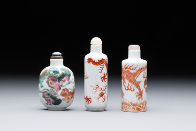 Three Chinese famille rose and iron-red 'Buddhist lion' and 'dragon' snuff bottles, 19th C.
