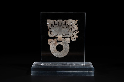 A Chinese nephrite jade 'bi' disc representing a Taotie mask, Han