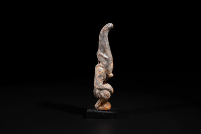 A Chinese jade carving of a crouched figure, possibly Hongshan culture