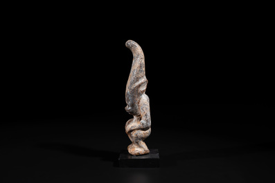 A Chinese jade carving of a crouched figure, possibly Hongshan culture