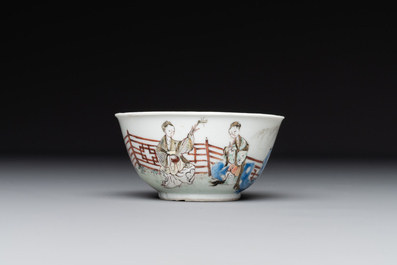 A Chinese famille rose cup and saucer with music making ladies, Yongzheng/Qianlong