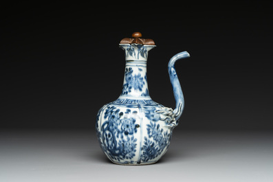 A fine Chinese blue and white 'pomegranate' kendi and a wooden cover, Wanli