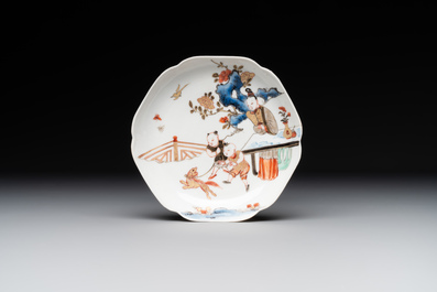 A Chinese polychrome cup and saucer with figures and a dog, Yongzheng