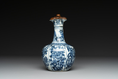 A fine Chinese blue and white 'pomegranate' kendi and a wooden cover, Wanli