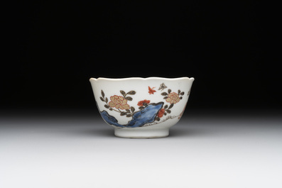 A Chinese polychrome cup and saucer with figures and a dog, Yongzheng