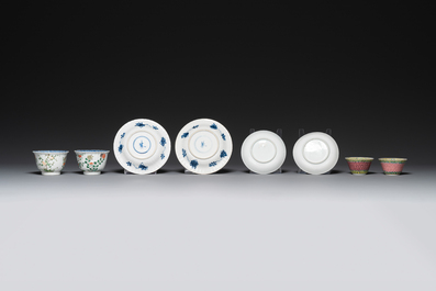 A pair of Chinese famille verte and a pair of famille rose cups and saucers, Kangxi/Yongzheng
