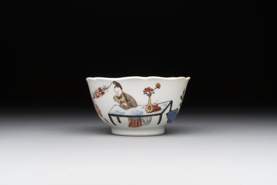 A Chinese polychrome cup and saucer with figures and a dog, Yongzheng