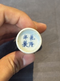 A Chinese copper-red snuff bottle with travellers in a landscape, Qianlong mark, 19th C.