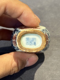 A Chinese blue, white and copper-red snuff 'deer' bottle, Yongzheng mark and of the period
