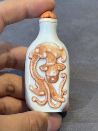 A Chinese moulded iron-red 'chilong' snuff bottle, 19th C.