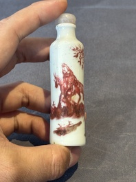 A Chinese copper-red snuff bottle with travellers in a landscape, Qianlong mark, 19th C.