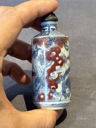 Three Chinese blue, white and copper-red snuff bottles, 19th C.