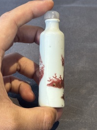 A Chinese copper-red snuff bottle with travellers in a landscape, Qianlong mark, 19th C.