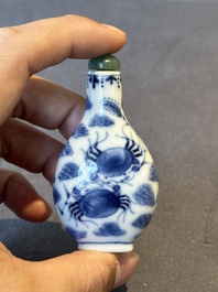 Two Chinese blue, white and copper-red snuff bottles and a blue and white 'crab' snuff bottle, Chenghua and Qianlong mark, 19th C.