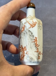 A Chinese iron-red and grisaille snuff bottle with monkeys at the Shuilian cave, 19th C.