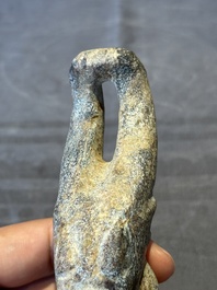 A Chinese jade carving of a crouched figure, possibly Hongshan culture