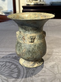 A Chinese archaic bronze ritual wine vessel with buffalo heads, 'zhi 觯', Western Zhou