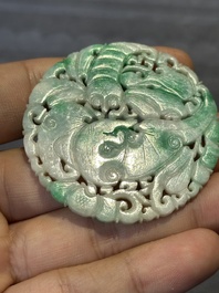 Two Chinese round jade plaques on carved wooden stands, 19th C.