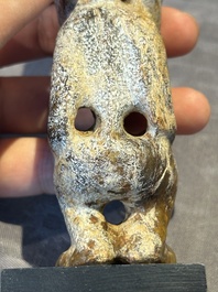 A Chinese jade carving of a crouched figure, possibly Hongshan culture