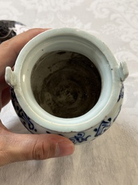 A Chinese blue and white tripod censer with floral design and a wooden cover, Ming