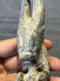 A Chinese jade carving of a crouched figure, possibly Hongshan culture