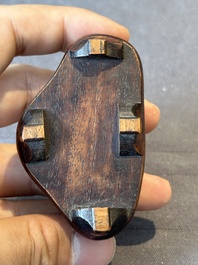 A Chinese bronze paperweight in the form of 'Shi De 拾得' on wooden stand, 16th C.