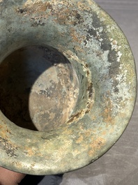 A Chinese archaic bronze ritual wine vessel with buffalo heads, 'zhi 觯', Western Zhou