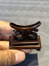 Two Chinese round jade plaques on carved wooden stands, 19th C.