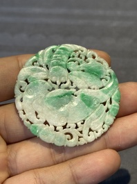 Two Chinese round jade plaques on carved wooden stands, 19th C.