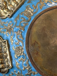 A Chinese gilt and champlev&eacute; enamelled bronze bowl with Buddhas in relief, 19/20th C.