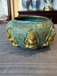 A Chinese gilt and champlev&eacute; enamelled bronze bowl with Buddhas in relief, 19/20th C.