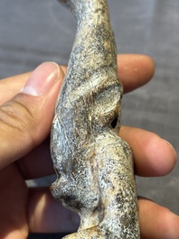 A Chinese jade carving of a crouched figure, possibly Hongshan culture