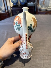 Two Chinese famille rose vases, two teapots and a Japanese wucai ewer, 19th C.