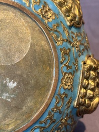 A Chinese gilt and champlev&eacute; enamelled bronze bowl with Buddhas in relief, 19/20th C.