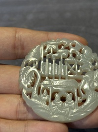 Two Chinese round jade plaques on carved wooden stands, 19th C.