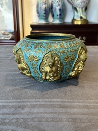A Chinese gilt and champlev&eacute; enamelled bronze bowl with Buddhas in relief, 19/20th C.