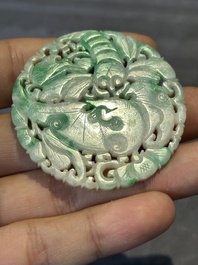 Two Chinese round jade plaques on carved wooden stands, 19th C.