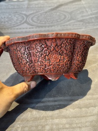 A Chinese red cinnabar lacquer jardiniere with floral design, Yongzheng/Qianlong