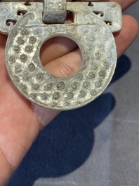 A Chinese nephrite jade 'bi' disc representing a Taotie mask, Han
